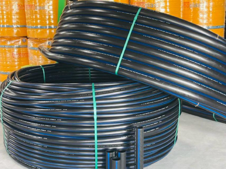 Yellow water tanks behind HDPE pipe coils